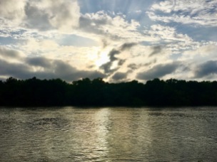 The stormy sunset on the river was beautiful.